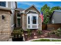 Well-manicured front yard features a beautiful bay window and an American flag waving in the breeze at 6255 Collegiate Dr, Highlands Ranch, CO 80130