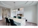 Dining room with a tray ceiling, modern lighting, and a formal dining table with seating for six at 710 Inca Pkwy, Boulder, CO 80303