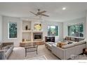 Spacious living room with neutral tones, fireplace, ceiling fan, and multiple windows providing ample light at 710 Inca Pkwy, Boulder, CO 80303