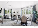 Bright living room featuring a gray sofa set, many windows, and a round dining table at 800 Mohawk Dr, Boulder, CO 80303