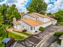 An aerial view showcasing the home's roofline, garages, landscaping, and driveway at 8423 Everett Way # A, Arvada, CO 80005