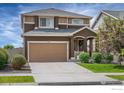 Charming two-story home featuring a spacious two car garage and well-maintained landscaping at 970 Auburn Dr, Erie, CO 80516