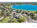 Aerial view of a blue home near a scenic lake, highlighted by a circular frame at 1067 W Alder St, Louisville, CO 80027