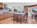 Spacious kitchen with a large island, seating, stainless steel appliances, and beautiful hardwood floors at 1067 W Alder St, Louisville, CO 80027