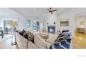 Bright living room with a fireplace, hardwood floors, and neutral furniture at 10950 Elk Horn Run, Littleton, CO 80125