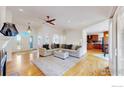 Spacious living room featuring hardwood floors and seamless transition to the kitchen at 10950 Elk Horn Run, Littleton, CO 80125