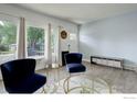 Bright living room with hardwood floors, large windows, and stylish decor at 112 Dawson Pl, Longmont, CO 80504