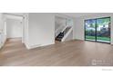Bright entryway with hardwood floors, staircase, and view of the backyard at 1304 Ceres Dr, Lafayette, CO 80026