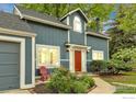 A delightful home featuring an attractive blue exterior and vibrant landscaping at 1304 Ceres Dr, Lafayette, CO 80026