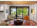 A cozy living room filled with natural light and stylish furniture and a large sliding door to the backyard at 1579 W Costilla Pl, Littleton, CO 80120