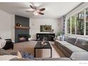 Cozy living room featuring a modern fireplace, large windows, and comfortable seating area at 1682 Crestview Ln, Erie, CO 80516