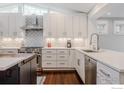Modern kitchen showcases white cabinets, stainless steel appliances, and elegant backsplash at 1816 Mariposa Ave, Boulder, CO 80302