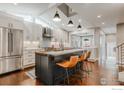 Bright, open kitchen features modern appliances, island with seating, and sleek countertops at 1816 Mariposa Ave, Boulder, CO 80302