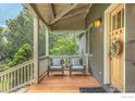 Inviting front porch with cozy seating, features beautiful wood flooring, and stylish decor at 1816 Mariposa Ave, Boulder, CO 80302