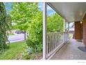 Inviting covered front porch, perfect for enjoying the serene neighborhood view at 1868 Princess Dr, Longmont, CO 80501