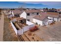 Aerial view of backyard featuring a pergola, landscaping, privacy fence, and detached garage at 20764 E 47Th Ave, Denver, CO 80249