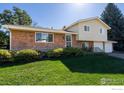 Inviting two-story home with lush green lawn, stone accents, and a well-maintained landscape at 2132 Gay St, Longmont, CO 80501