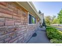 Close-up view of the home's exterior, featuring stone detailing and a well-maintained landscape at 2132 Gay St, Longmont, CO 80501