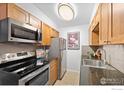 Efficient kitchen featuring stainless steel appliances and granite countertops at 252 N Pennsylvania St # 305, Denver, CO 80203