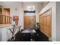 Spacious foyer with black tile flooring, modern lighting, and a sleek glass console table at 2777 S Elmira St # 17, Denver, CO 80231