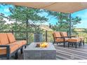 Cozy covered deck with a fire pit and mountain views at 279 Green Meadow Ln, Boulder, CO 80302