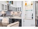 Modern kitchen with white cabinetry, granite countertops, and open shelving at 279 Green Meadow Ln, Boulder, CO 80302