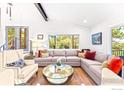 Bright living room featuring a large sectional sofa and natural light at 279 Green Meadow Ln, Boulder, CO 80302