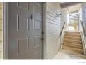 Condo front door, showing unit number, adjacent to stairs for upper levels at 3515 28Th St # 108, Boulder, CO 80301