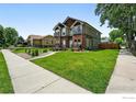 Exterior view of townhome showcasing well-maintained lawn and inviting curb appeal in a desirable neighborhood at 4039 N Clay St, Denver, CO 80211