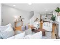 Bright, open-concept living area with hardwood floors, modern furnishings, and abundant natural light at 4039 N Clay St, Denver, CO 80211