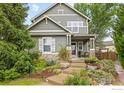 Charming two-story home featuring manicured landscaping, a stone foundation, and a welcoming front porch at 4219 Frederick Cir, Longmont, CO 80503