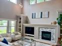 Bright living room with a fireplace, built-in shelving, and large windows offering natural light at 4219 Frederick Cir, Longmont, CO 80503