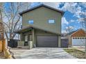 This exterior shows the modern home with its large garage and minimalist landscaping at 456 W Sycamore Ct, Louisville, CO 80027