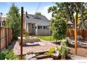 Inviting backyard patio with stone pavers, comfortable seating, and lush landscaping at 4594 Beach Ct, Denver, CO 80211