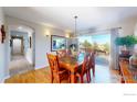 Dining room with hardwood floors, decorative chandelier and patio access with scenic view at 6260 Rain Dance Trl, Littleton, CO 80125