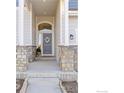 Charming front entry with stone accents, a decorative wreath, and neutral tones for a welcoming curb appeal at 675 Lene Ln, Berthoud, CO 80513