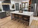 Modern kitchen with a large island with seating, stainless steel appliances, and custom cabinetry at 6969 Harvest Rd, Boulder, CO 80301