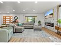 Cozy living room with a comfortable sectional sofa, decorative fireplace, and plenty of natural light at 6969 Harvest Rd, Boulder, CO 80301