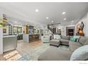 Open-concept living space seamlessly integrates the kitchen, living room, and staircase at 6969 Harvest Rd, Boulder, CO 80301