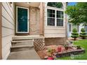 Close-up of front steps with brick detailing and potted plants creating a welcoming entrance at 7796 Xavier Ct, Westminster, CO 80030
