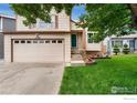 Inviting two-story home with a two-car garage and a lush green lawn, perfect for families at 7796 Xavier Ct, Westminster, CO 80030