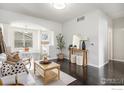 Open-concept living room featuring dark floors and plenty of natural light at 85 Uinta Way # 605, Denver, CO 80230