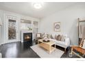 Comfortable living room with fireplace, dark floors, and plenty of natural light at 85 Uinta Way # 605, Denver, CO 80230