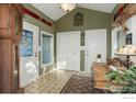 Welcoming foyer with tile floors, coat closet, and vintage furnishings at 8586 N 55Th St, Boulder, CO 80301