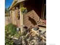 Charming front entrance with hanging flower baskets and rustic decor at 8586 N 55Th St, Boulder, CO 80301