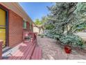 Charming red brick home with a stone tile walkway, and an outdoor patio at 915 19Th Ave, Longmont, CO 80501
