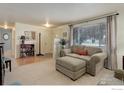 Inviting living room with neutral carpet, large window, and comfortable seating area at 915 19Th Ave, Longmont, CO 80501