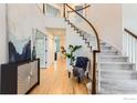 Welcoming foyer with hardwood floors, staircase, and elegant decor at 1069 Monarch Way, Superior, CO 80027