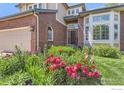Close up view of landscaped front yard with beautiful flowering plants at 1069 Monarch Way, Superior, CO 80027