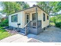 Charming single story home with neutral siding and a covered front porch entrance at 1233 Carolina Ave, Longmont, CO 80501